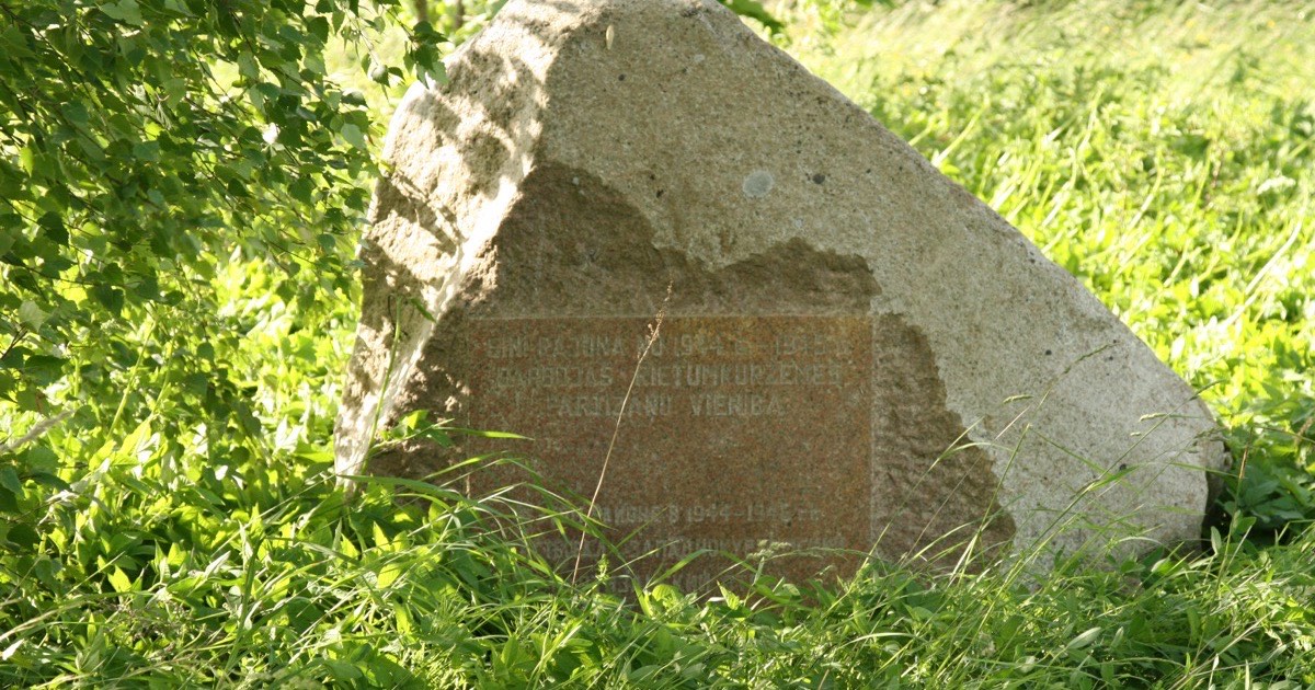 A stone war memorial with carved inscriptions