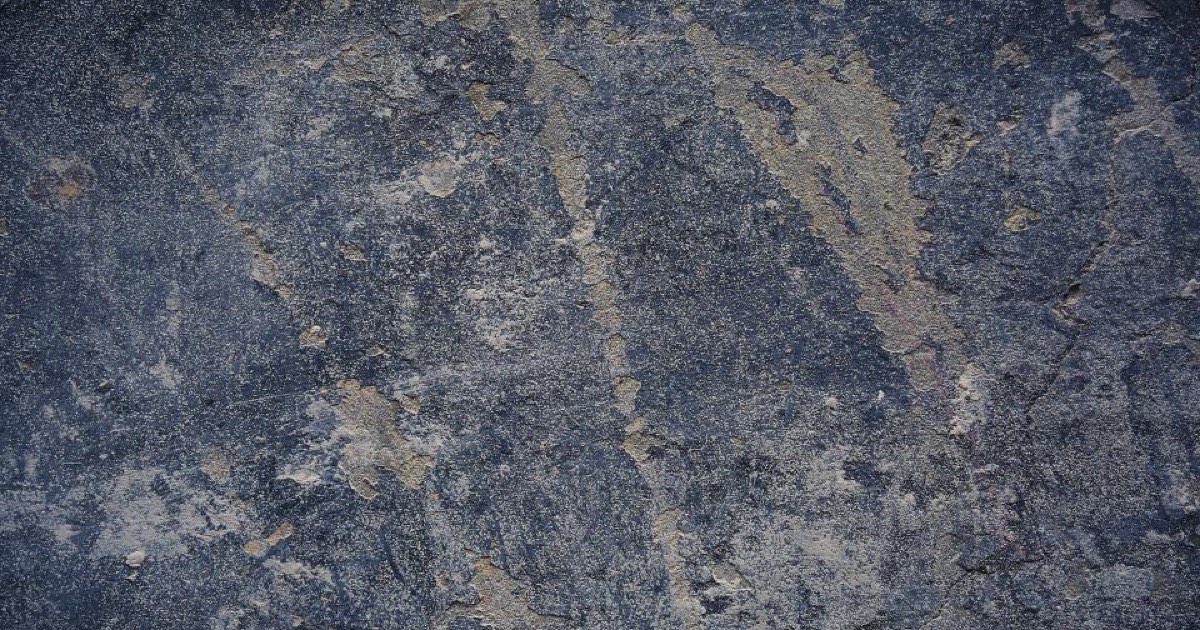 A stained concrete wall before cleaning