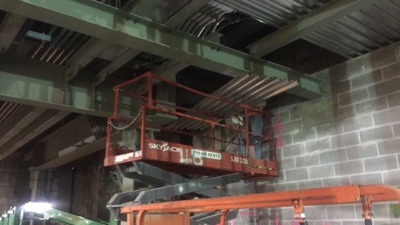 Structural steel beams being prepared for coating