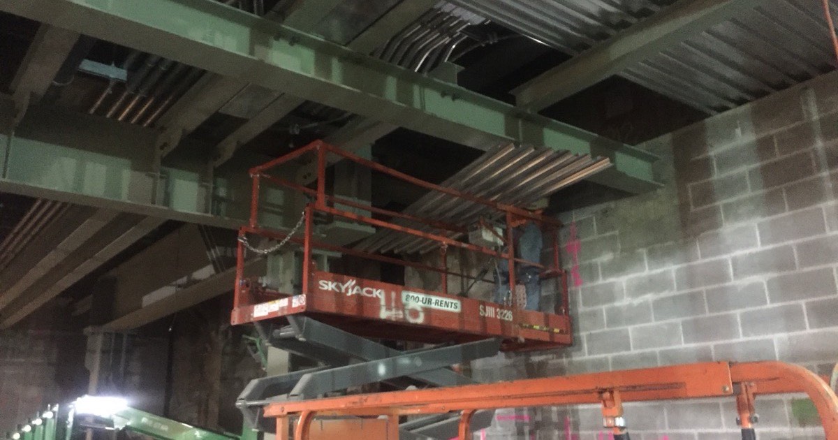 Structural steel beams being prepared for coating
