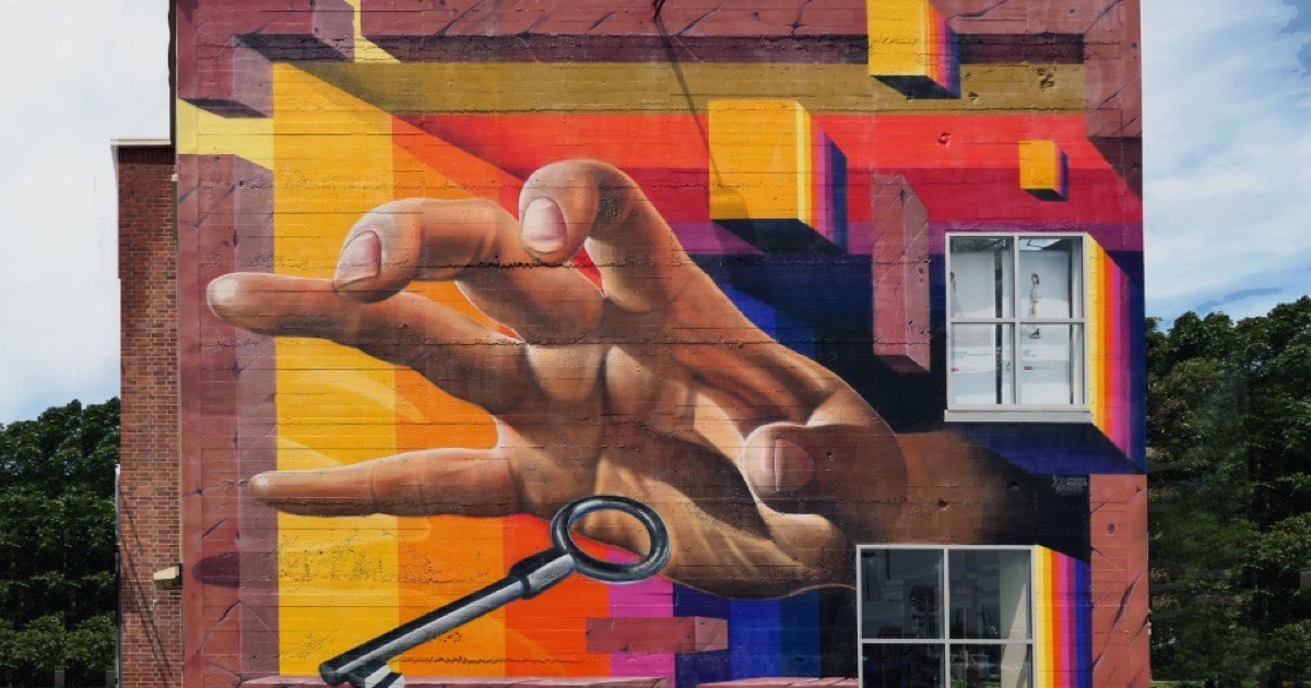 Graffiti sprayed across a red brick wall