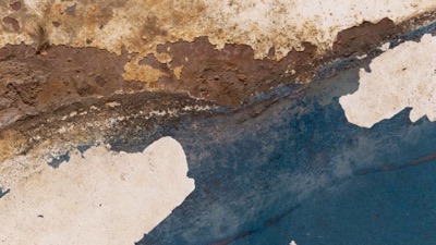Old paint flaking from a metal surface