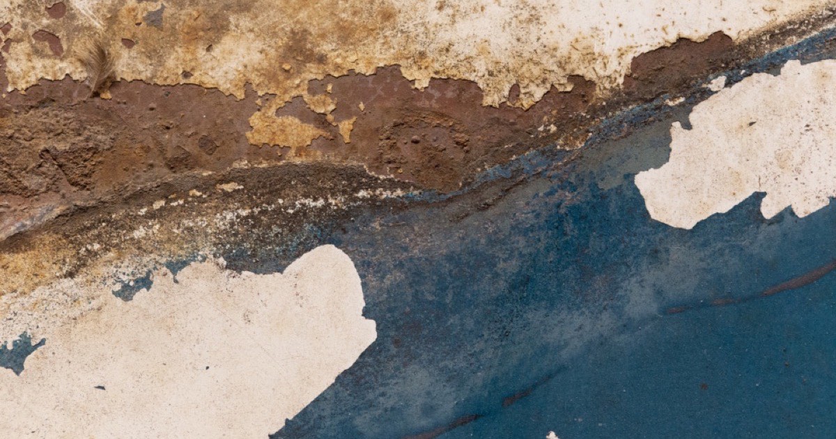 Old paint flaking from a metal surface