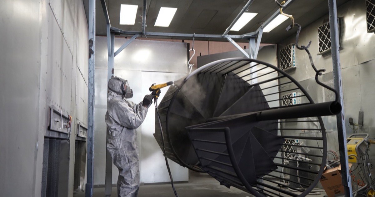 A powder coated metal panel being stripped