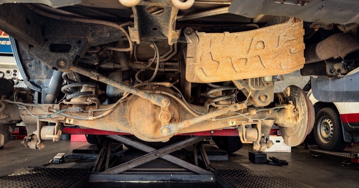 Underside of a vehicle with old undercoat being removed
