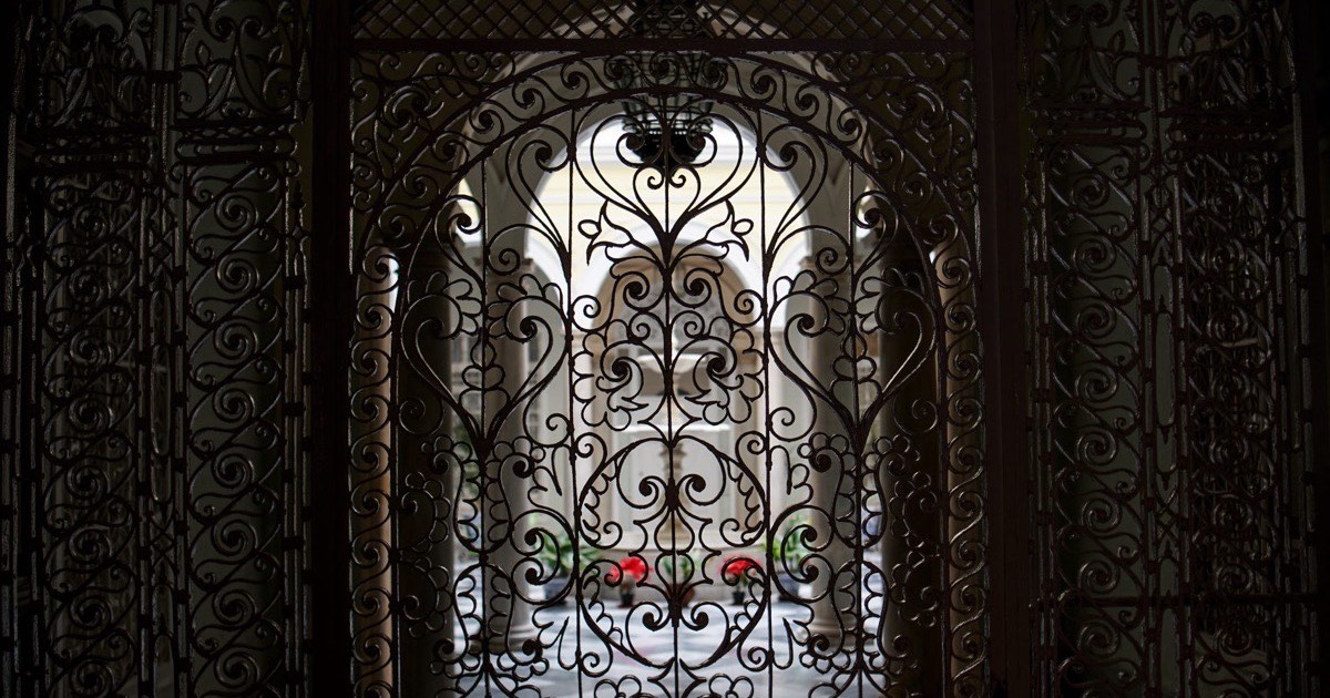 An ornamental wrought iron gate being restored