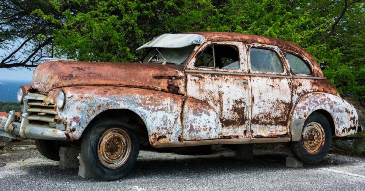 A rusty classic car panel before restoration