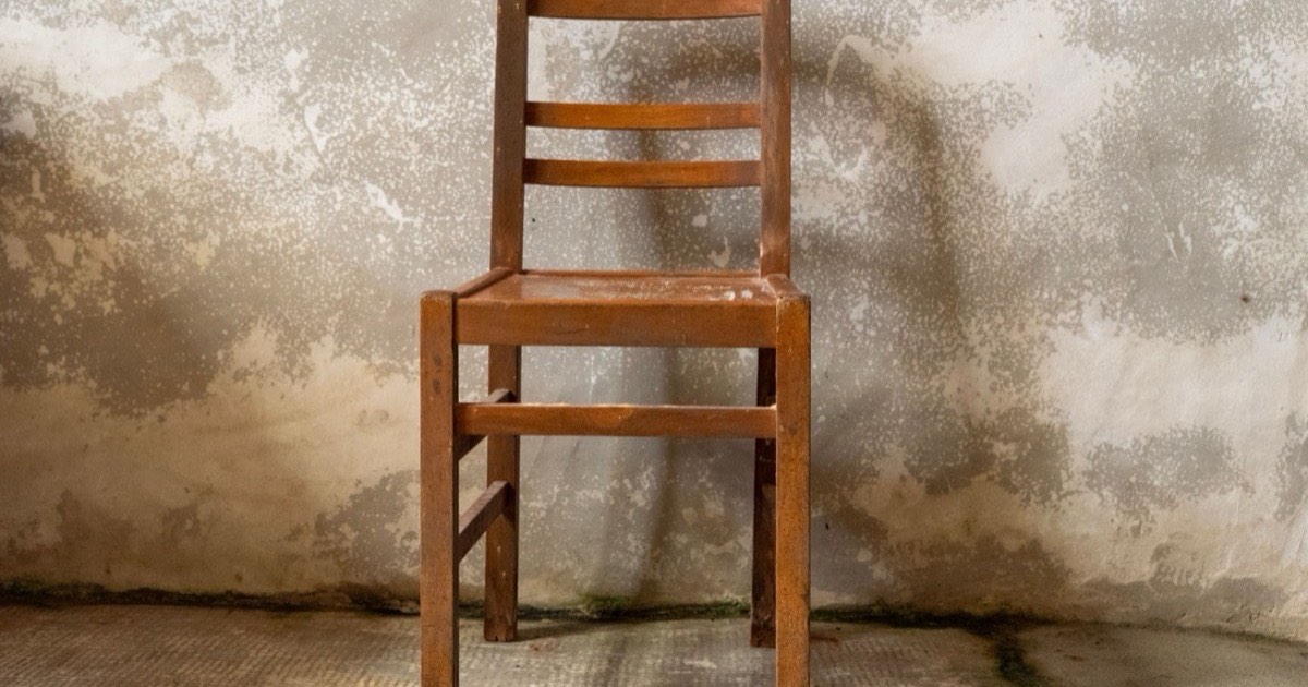 A wooden chair having its paint stripped